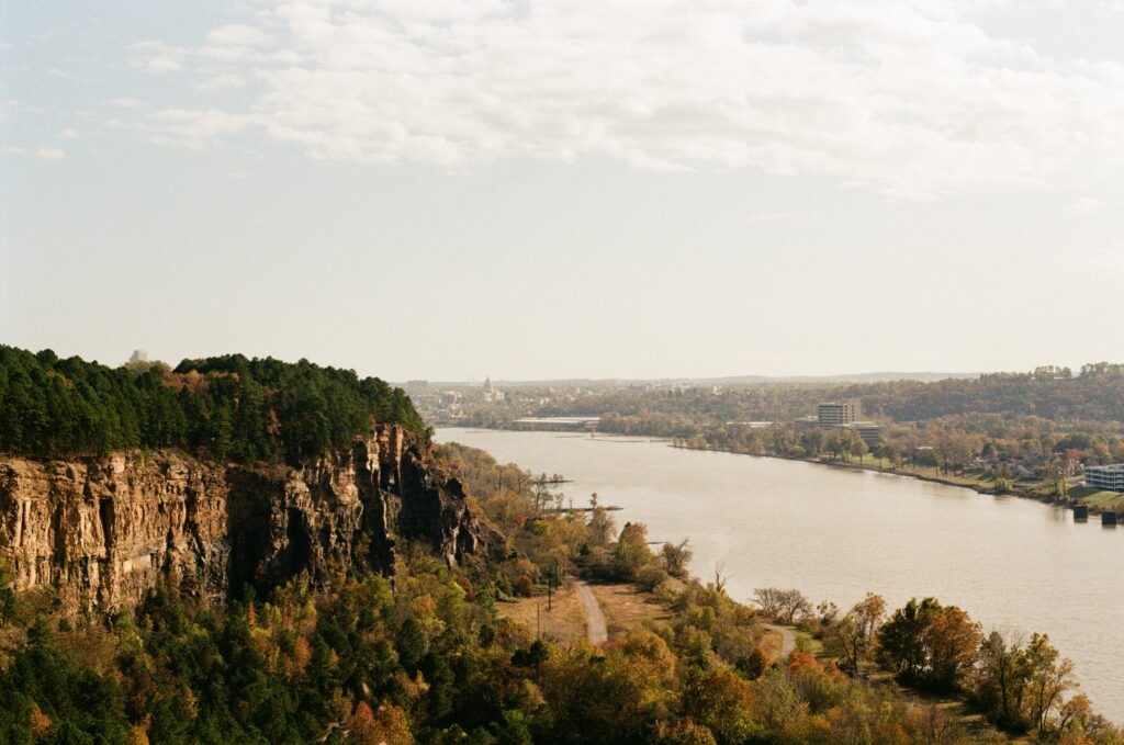 Image of the Arkansas River taken from a hill. Downtown Little Rock is visible in the distance.